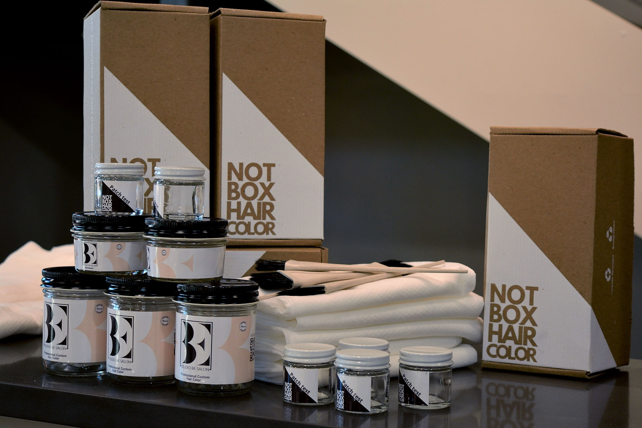 color enhancement collection jars and box on countertop