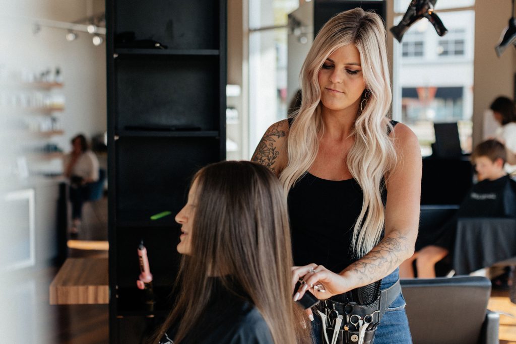 stylist styling hair at studio be salon in colorado