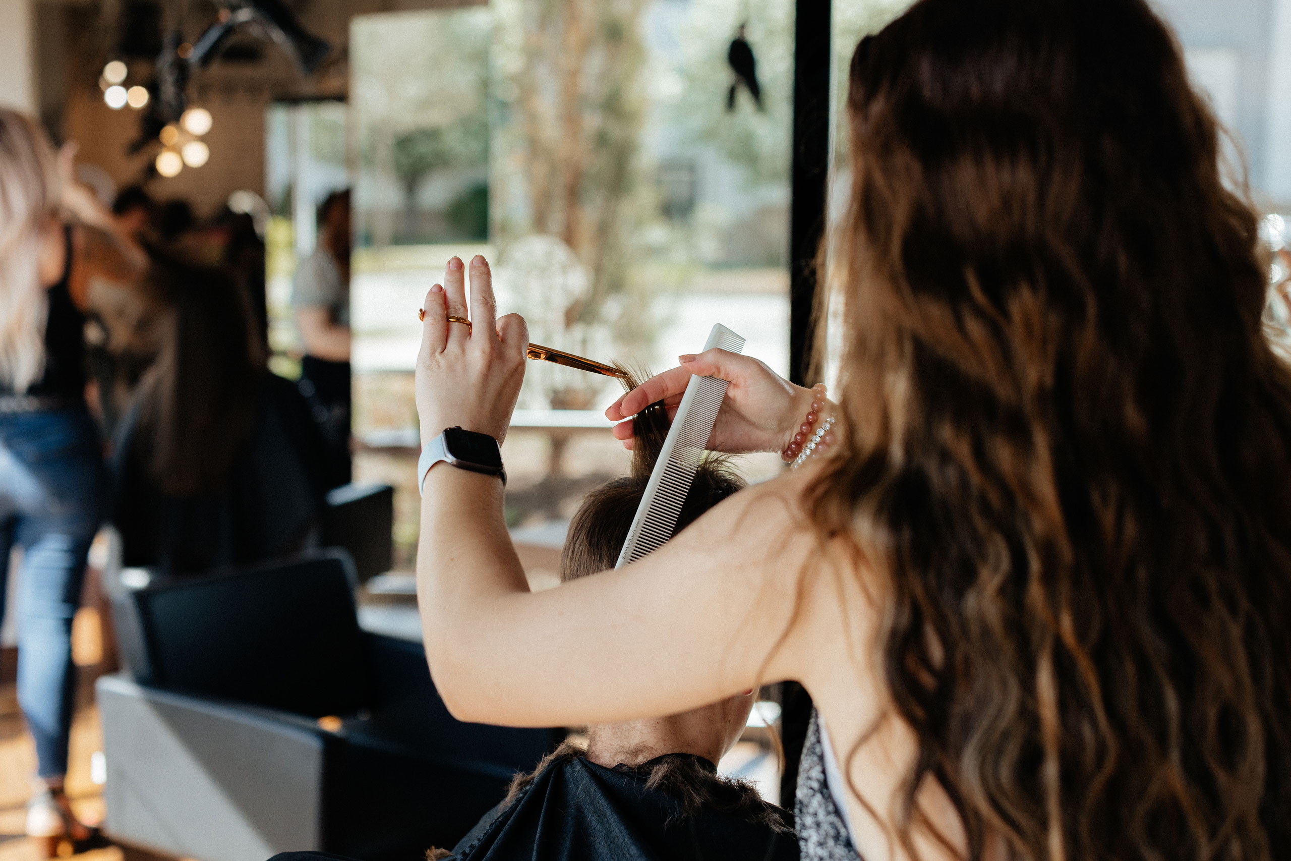 hair stylist doing hair at studio be salon